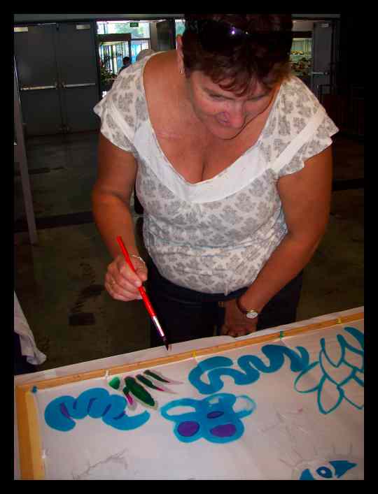 A lady learning how to paint on silk